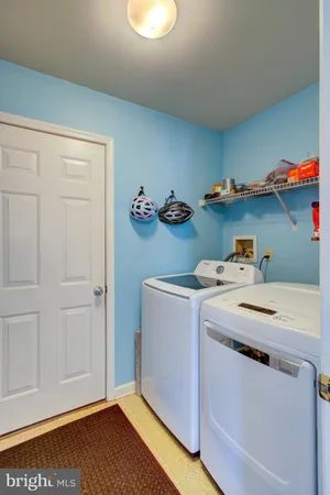 a bathroom with a sink a toilet and a window