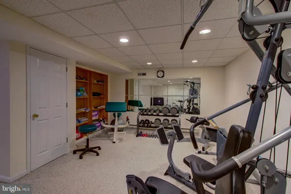 a room with gym equipment and a table