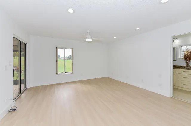 a bathroom with a granite countertop sink and mirror