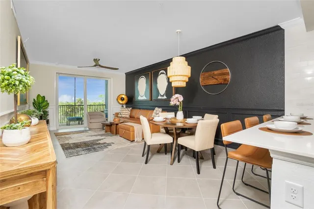 a living room with furniture a clock on wall and a window