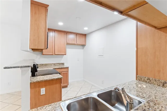a kitchen with a sink and a refrigerator