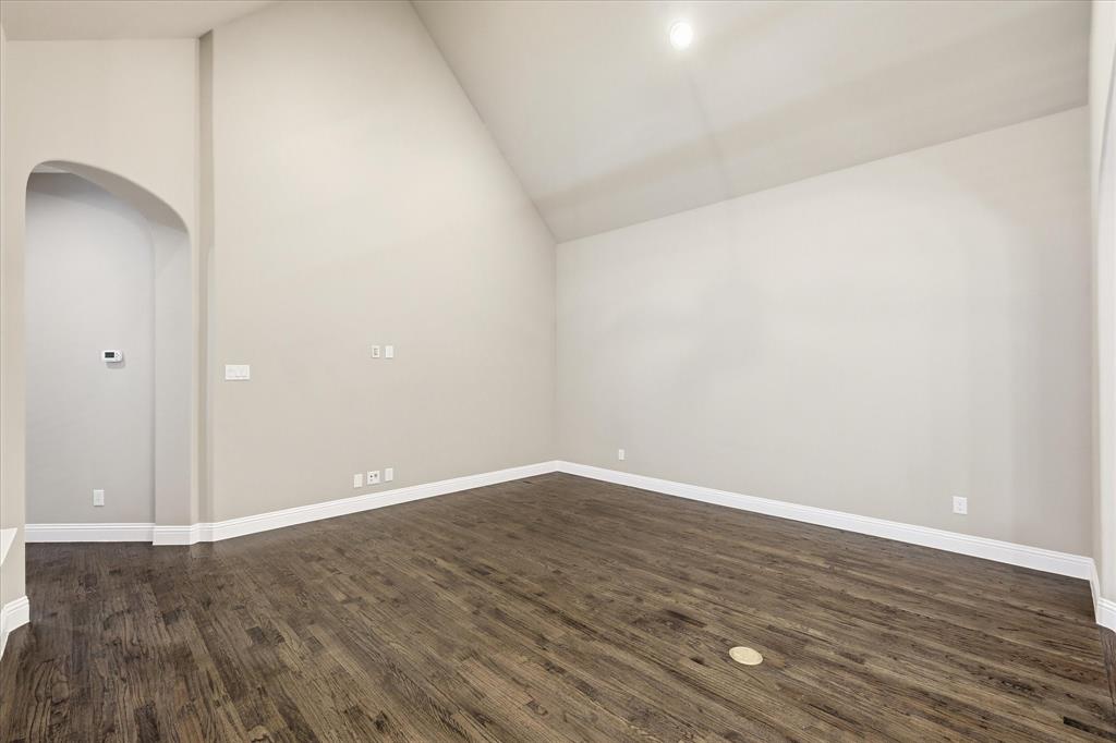 768 Huntingdon Street Coppell, TX 75019 - Photo 14 of 37 Spacious living room featuring high ceilings, neutral paint, recessed lighting, and rich wood flooring for a timeless, move-in-ready feel.