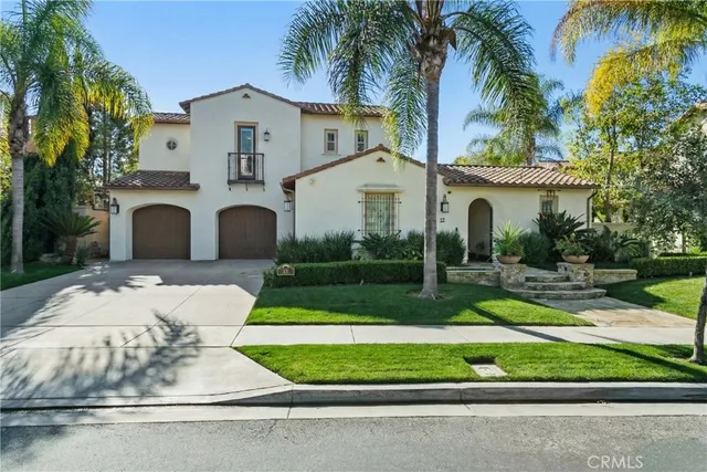 a front view of a house with a garden and plants
