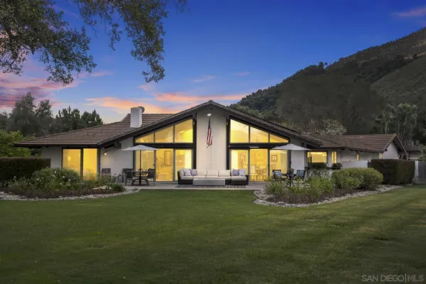 a front view of house with outdoor space and garden