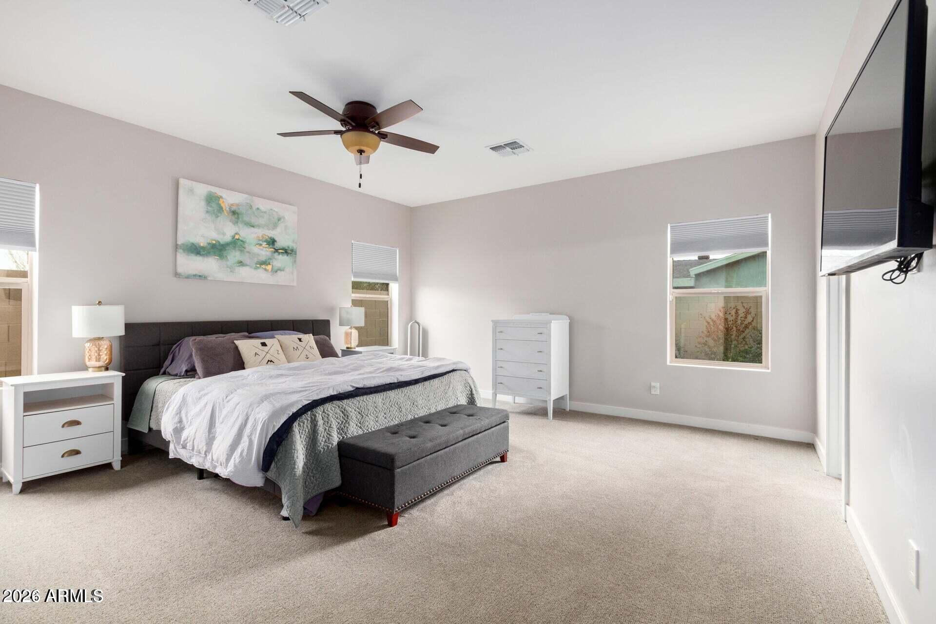 2647 East Contention Mine Road Phoenix, AZ 85032 - Photo 13 of 34 a spacious bedroom with a bed and a flat screen tv