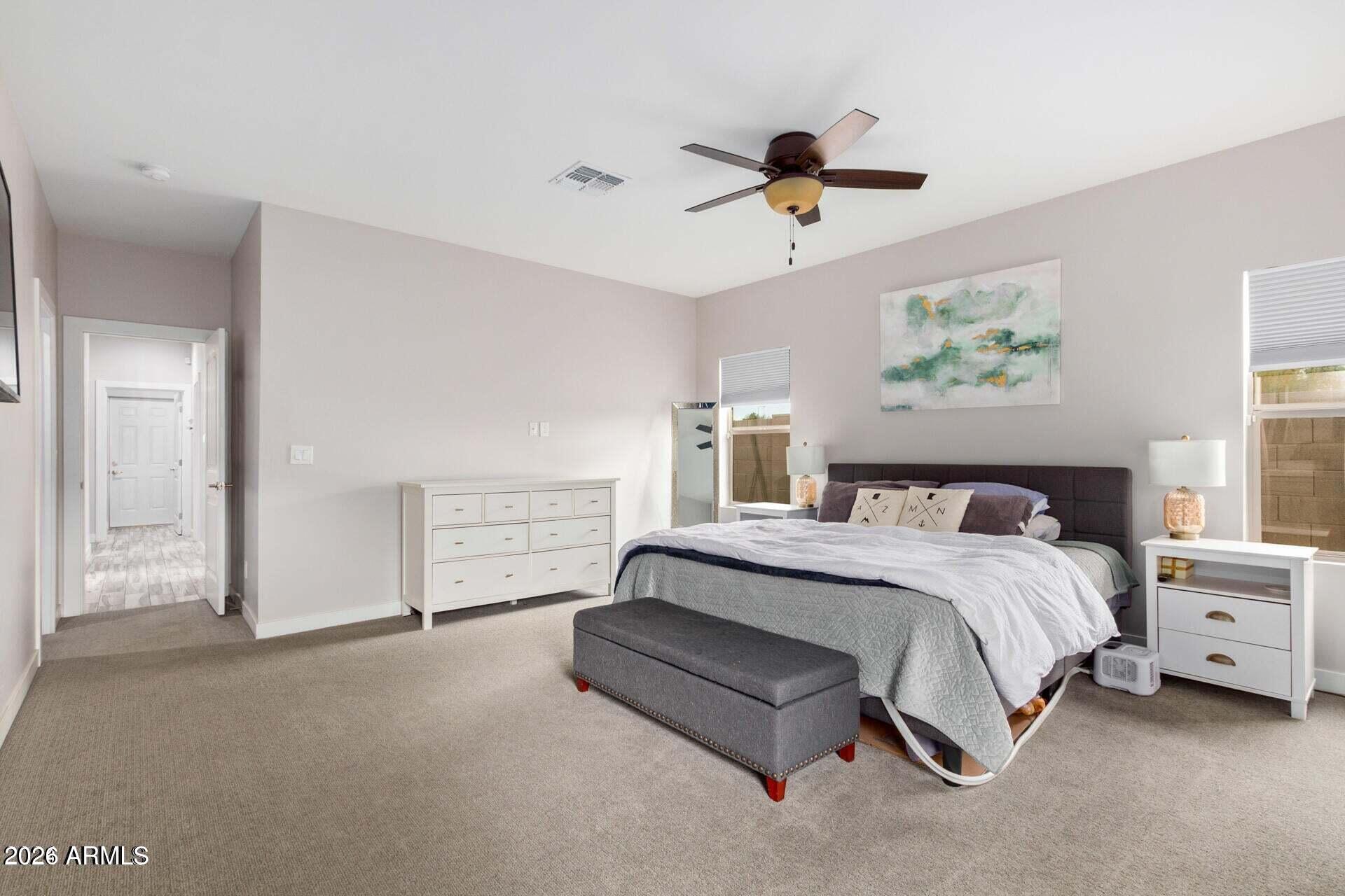 2647 East Contention Mine Road Phoenix, AZ 85032 - Photo 14 of 34 a spacious bedroom with a bed and a cabinets