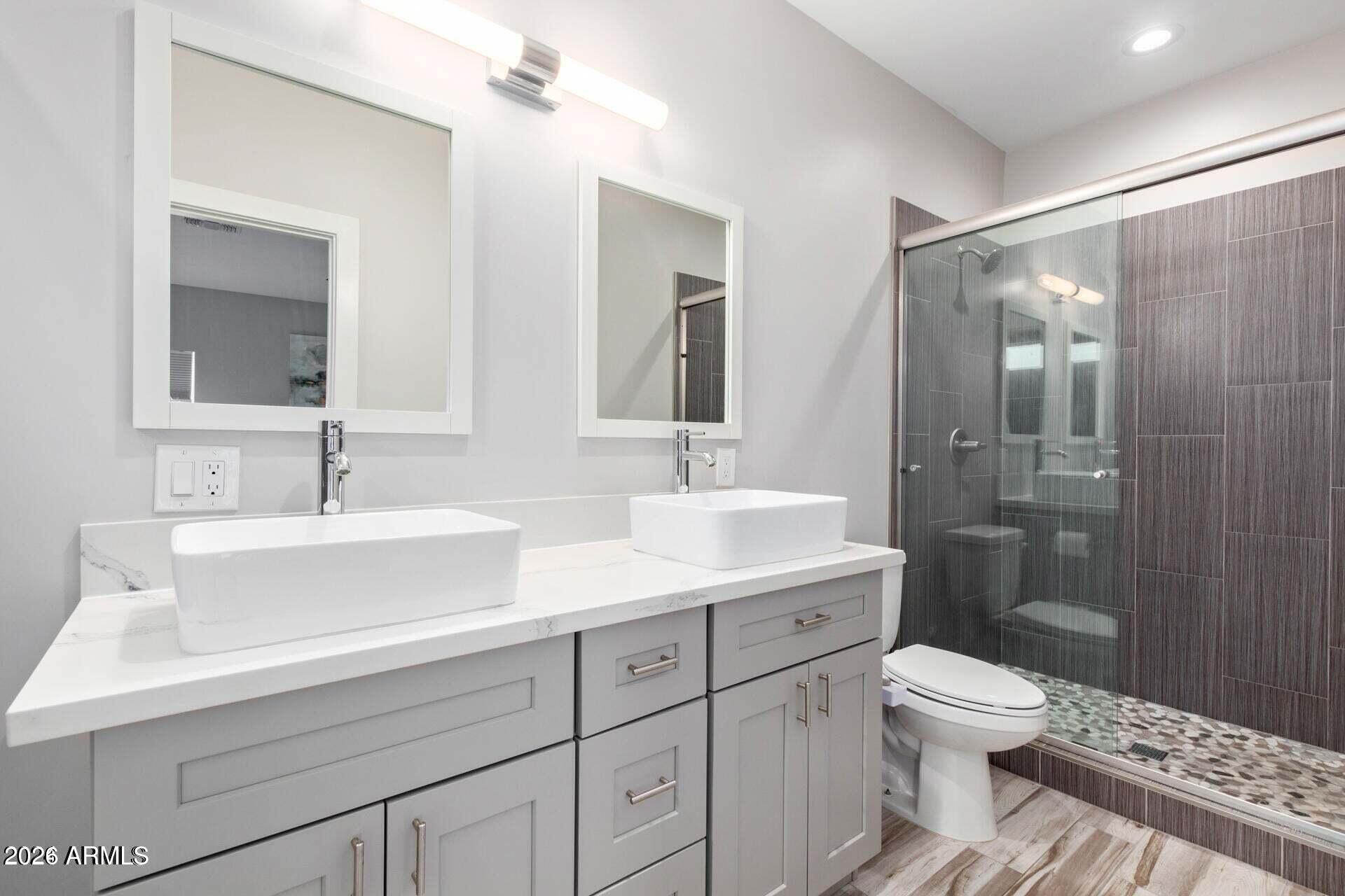 2647 East Contention Mine Road Phoenix, AZ 85032 - Photo 16 of 33 a bathroom with a sink a toilet a shower and a mirror