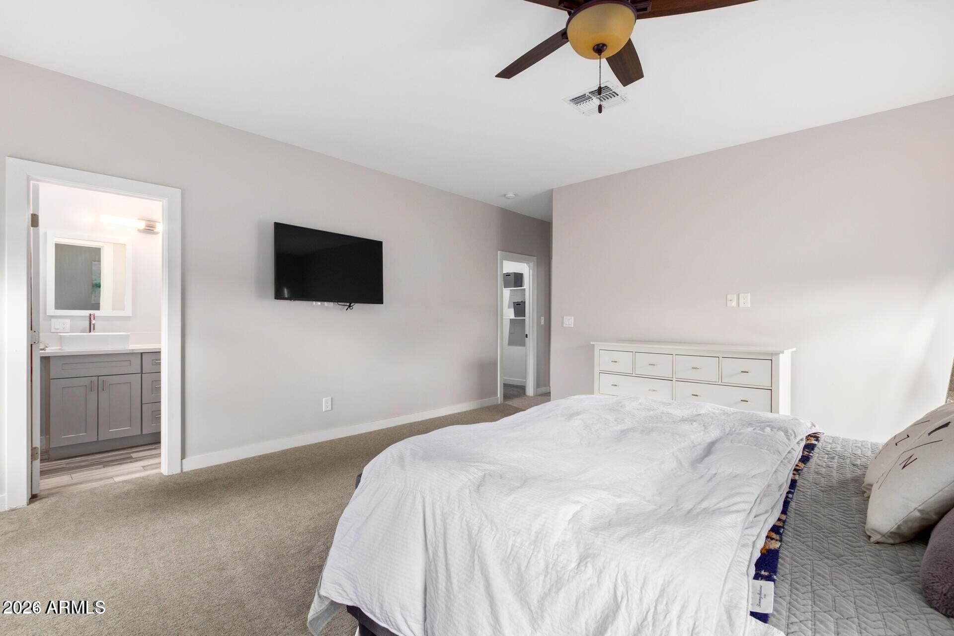 2647 East Contention Mine Road Phoenix, AZ 85032 - Photo 15 of 34 a bedroom with a bed and a flat screen tv