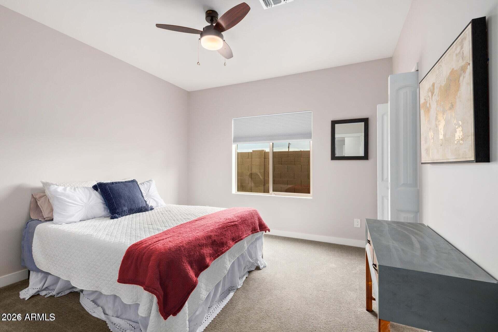 2647 East Contention Mine Road Phoenix, AZ 85032 - Photo 20 of 33 a bedroom with a large bed and a chandelier