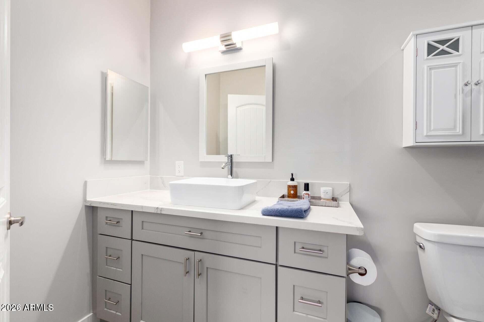 2647 East Contention Mine Road Phoenix, AZ 85032 - Photo 22 of 34 a bathroom with a sink toilet vanity and mirror