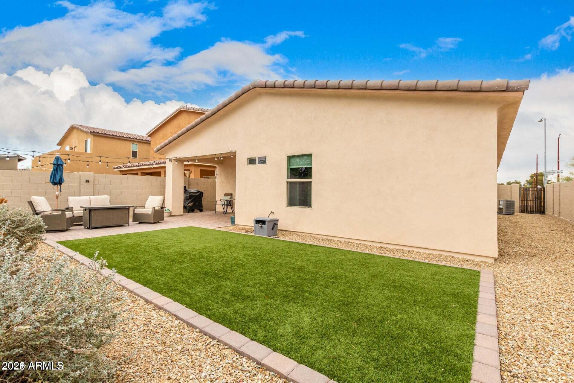 2647 East Contention Mine Road Phoenix, AZ 85032 - Photo 29 of 33 a view of a backyard with couches under an umbrella