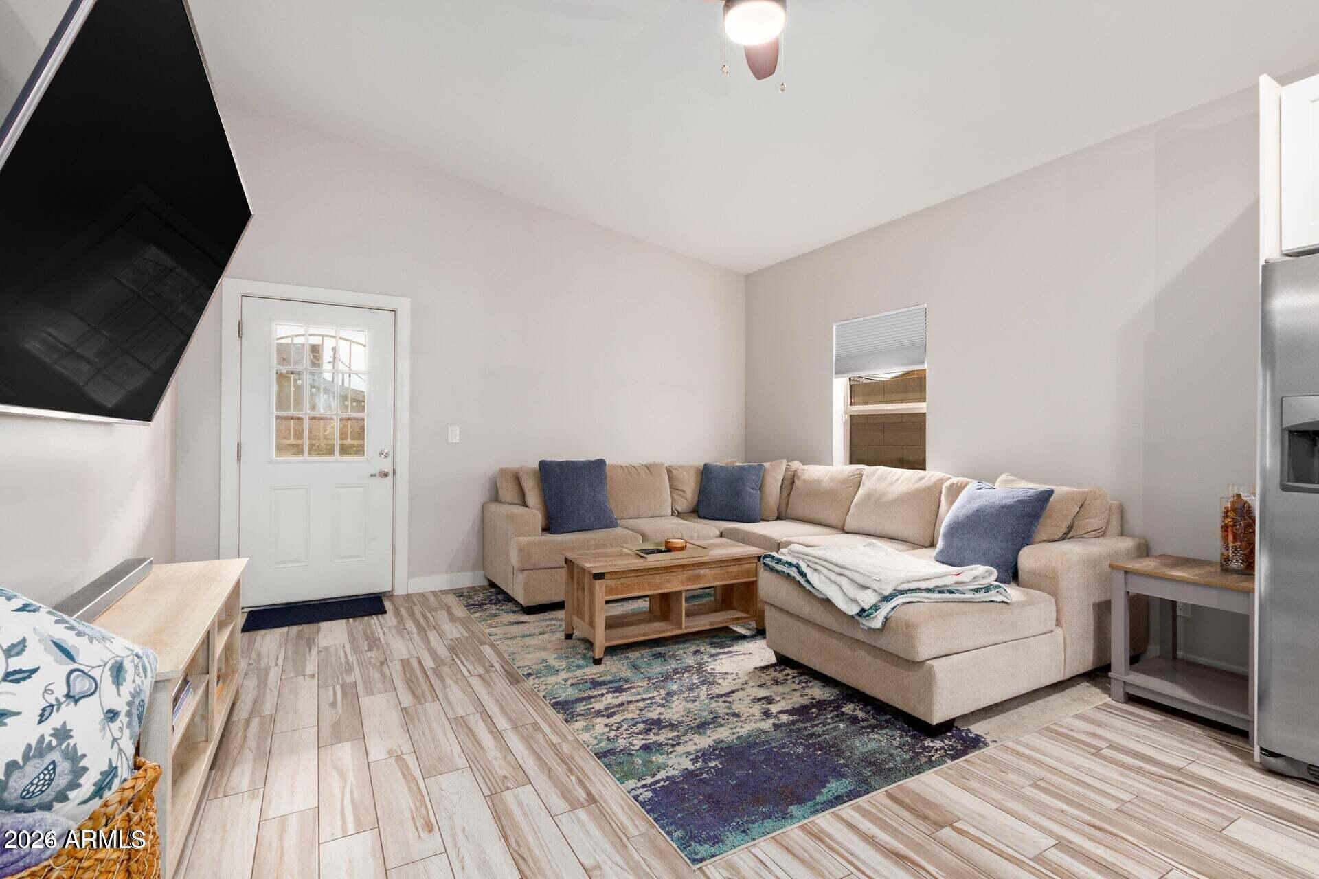 2647 East Contention Mine Road Phoenix, AZ 85032 - Photo 2 of 34 a living room with furniture and a wooden floor