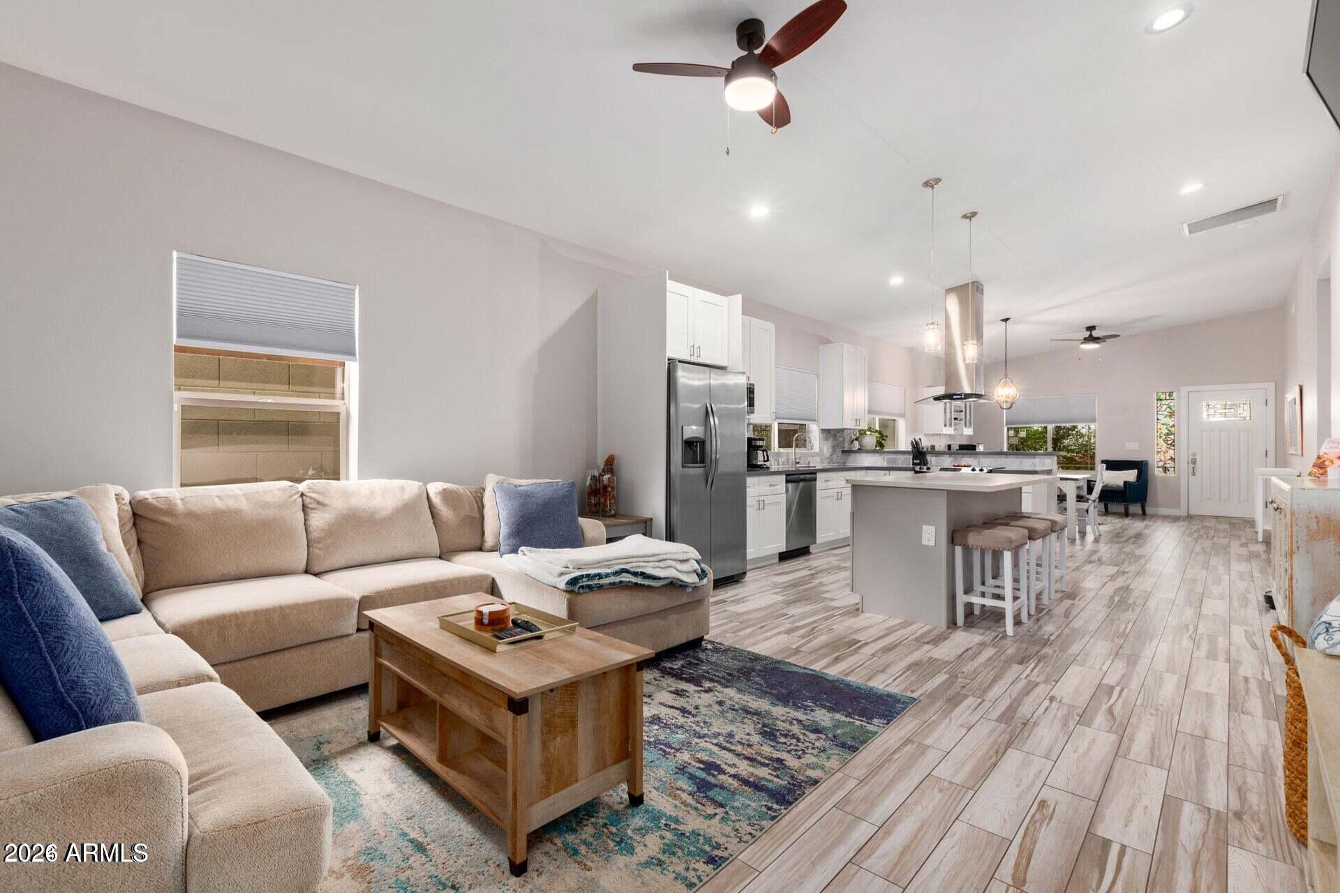 2647 East Contention Mine Road Phoenix, AZ 85032 - Photo 3 of 33 a living room with furniture and kitchen view