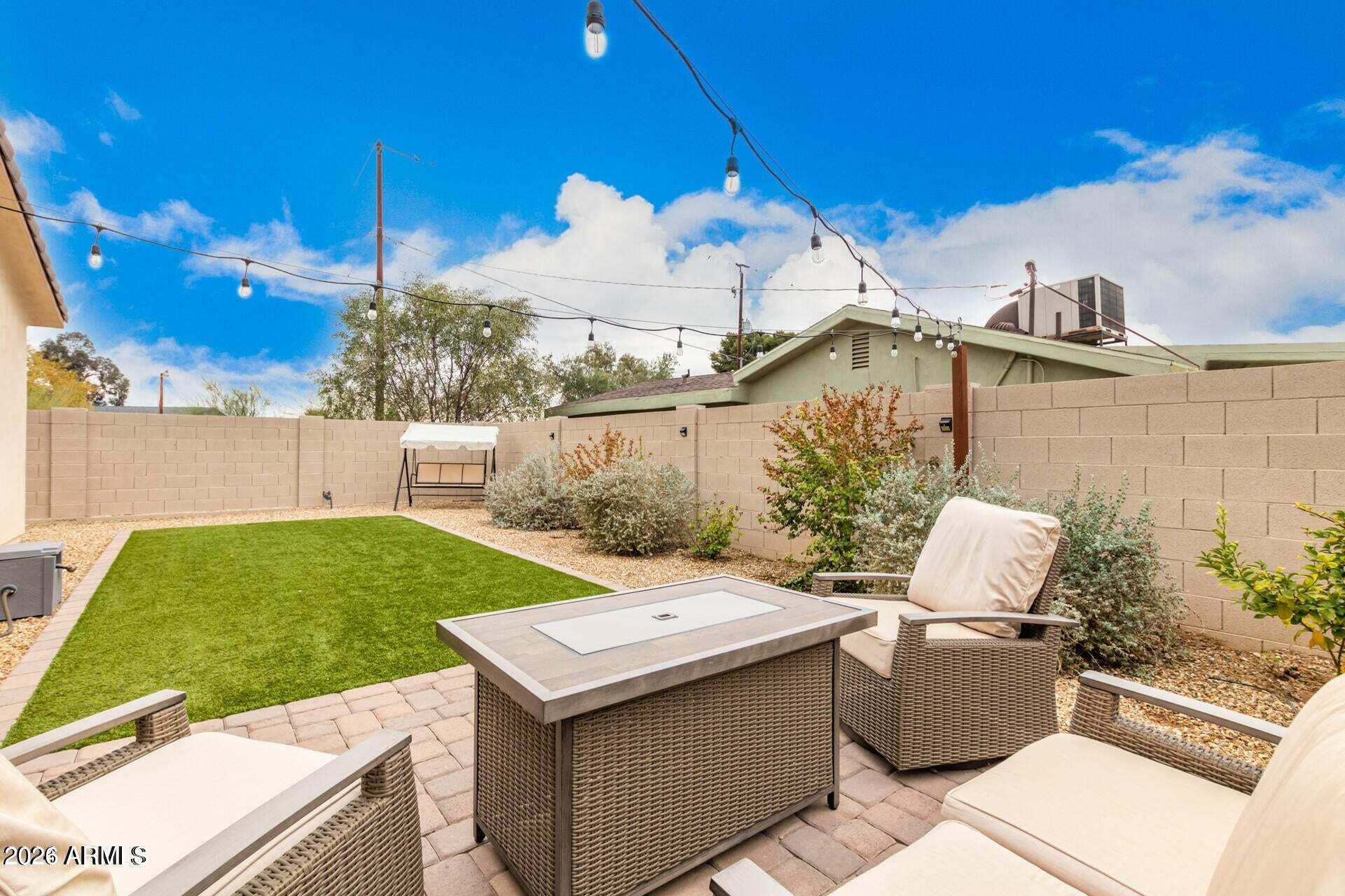 2647 East Contention Mine Road Phoenix, AZ 85032 - Photo 32 of 33 a view of a patio with table and chairs with wooden fence