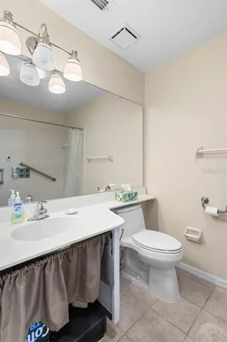 a bedroom with a bed a mirror and a window