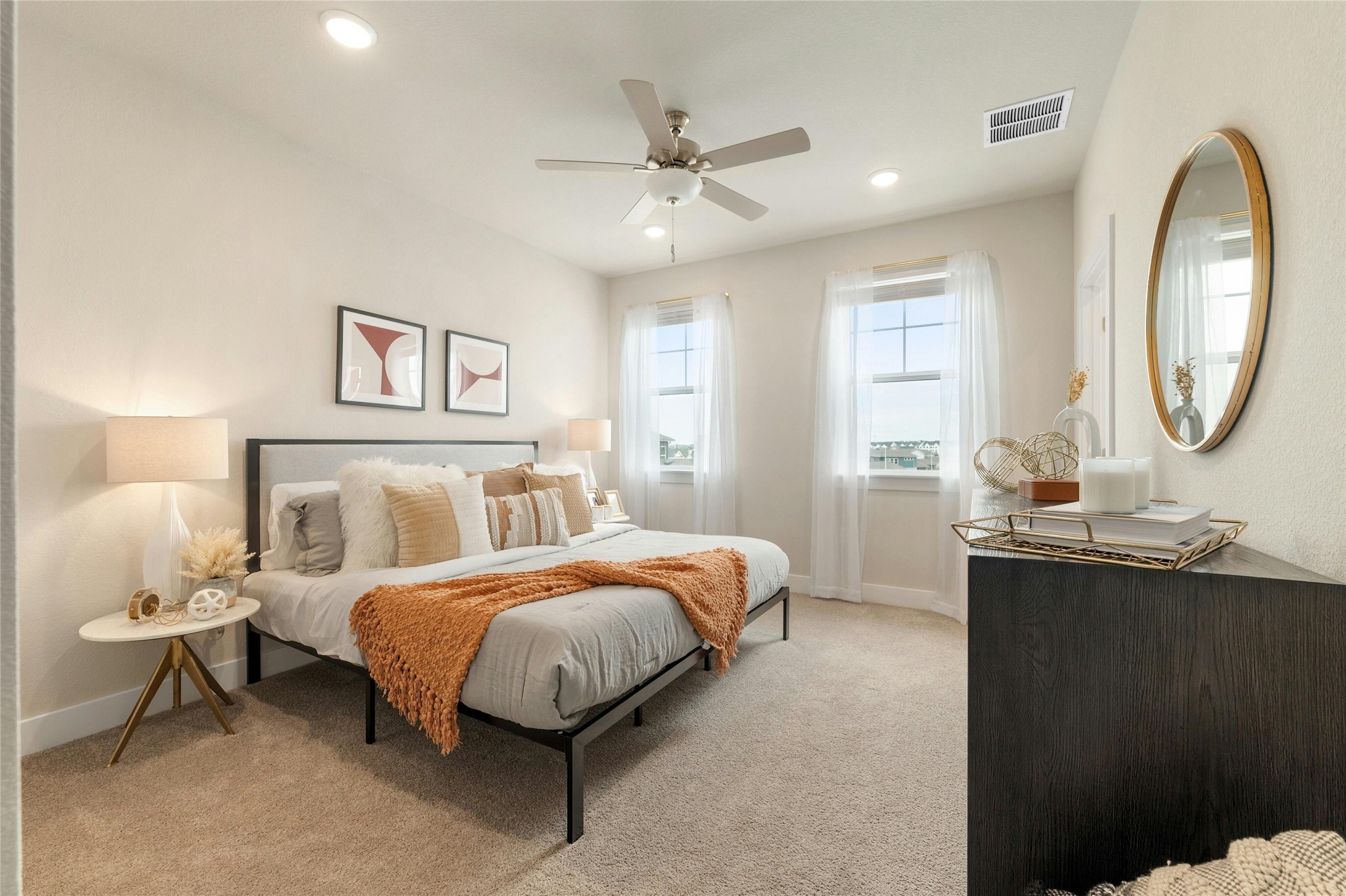 5804 Rotunda View Austin, TX 78747 - Photo 11 of 27 Recessed lighting and a ceiling fan illuminate this inviting bedroom, featuring soft carpeting and sun-filled windows.