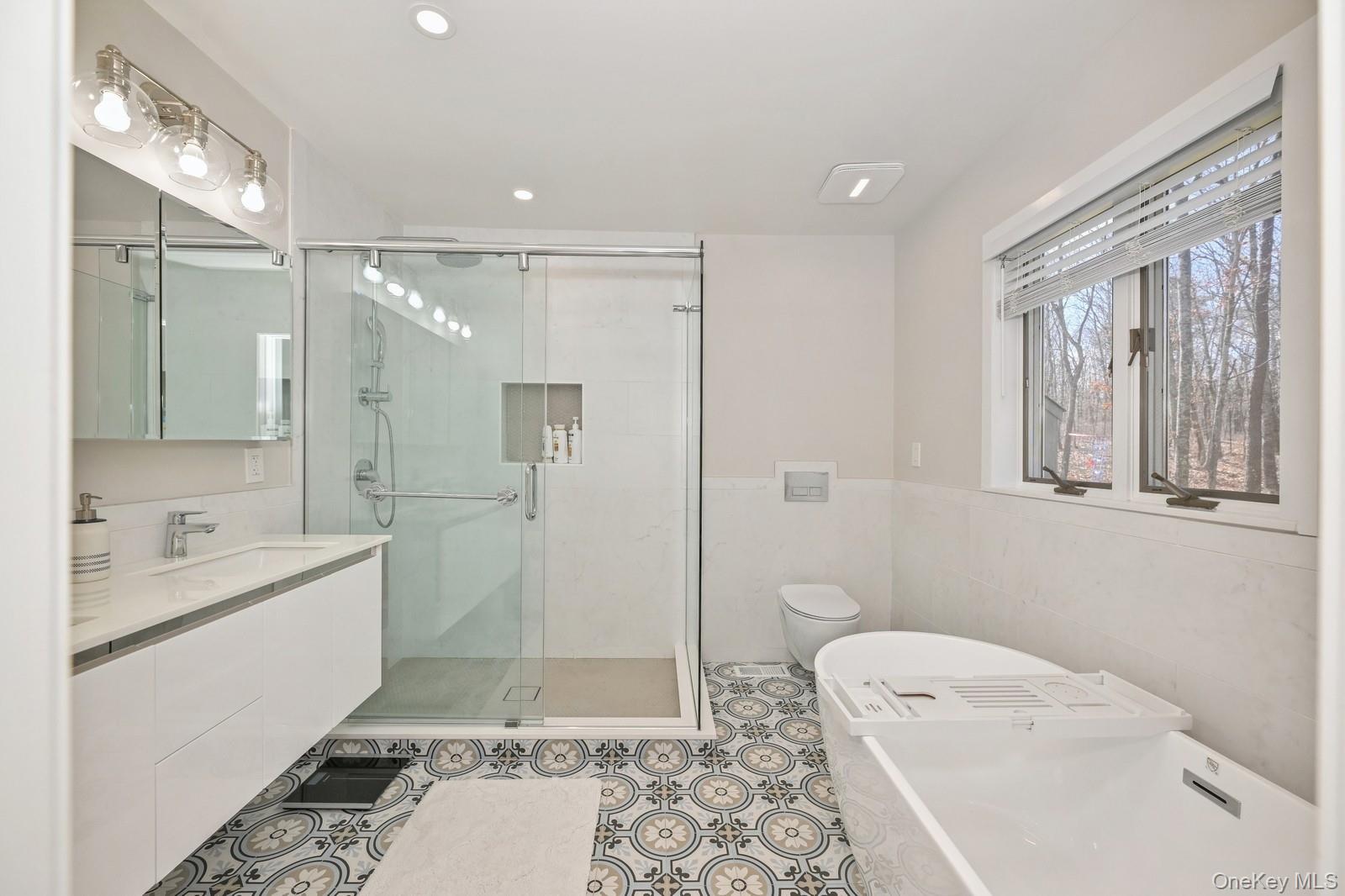 16 Hildreth Road Hampton Bays, NY 11946 - Photo 21 of 29 a bathroom with a tub sink toilet and a mirror