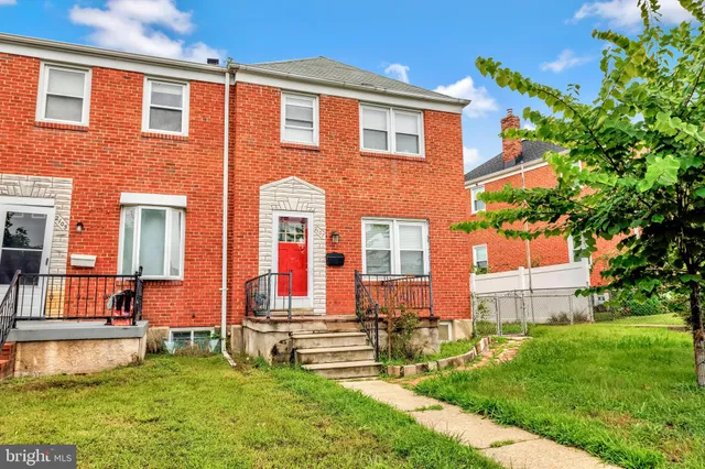 a front view of house with yard and outdoor seating