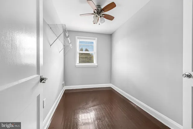 a view of a room with wooden floor and windows