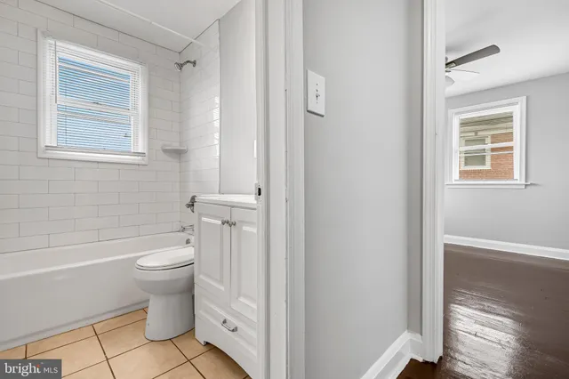 a white toilet sitting next to a bathroom sink