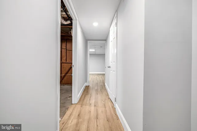 a view of a hallway with wooden floor