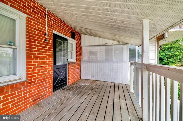 a view of a backyard with wooden floor and fence