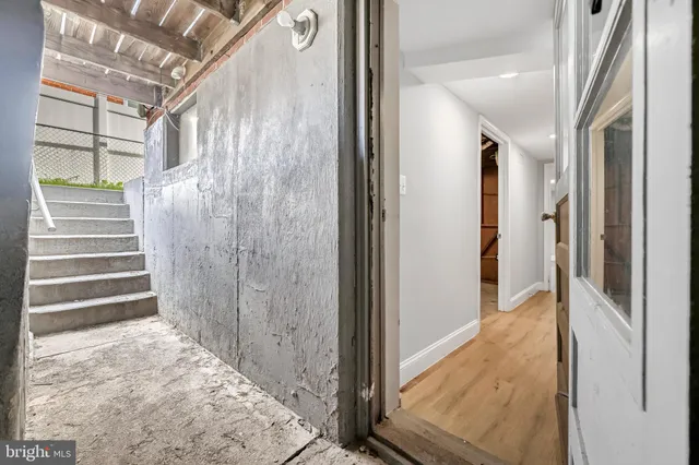 a view of entryway with wooden floor and stairs