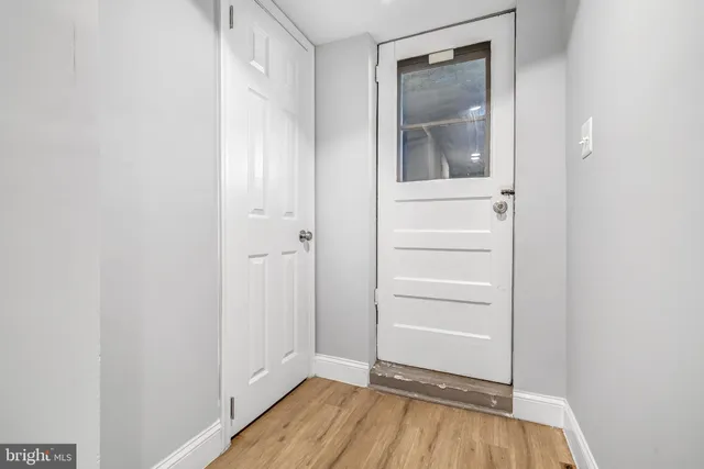 a view of a room with wooden floor and closet