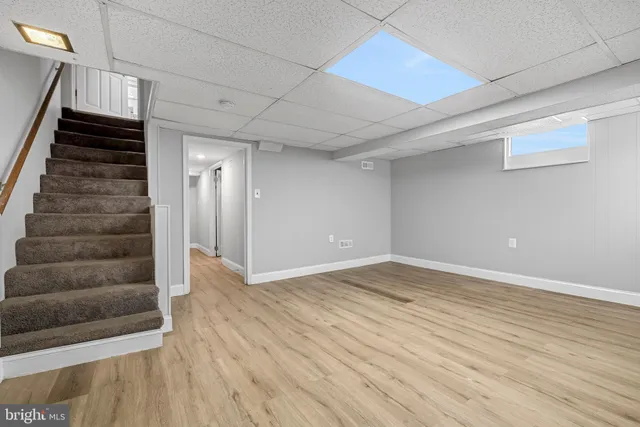 a view of an empty room with stairs and ventilation