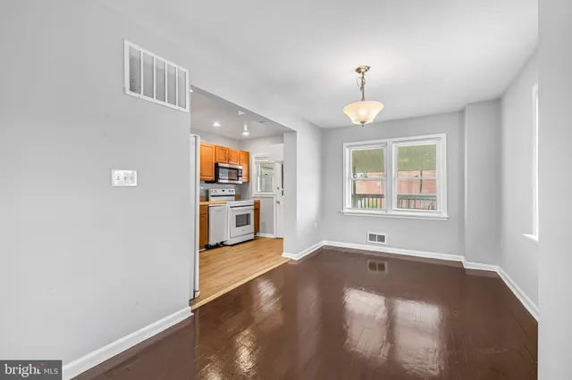 wooden floor in an empty room with a window