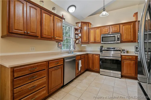 a kitchen with stainless steel appliances granite countertop a stove microwave and sink