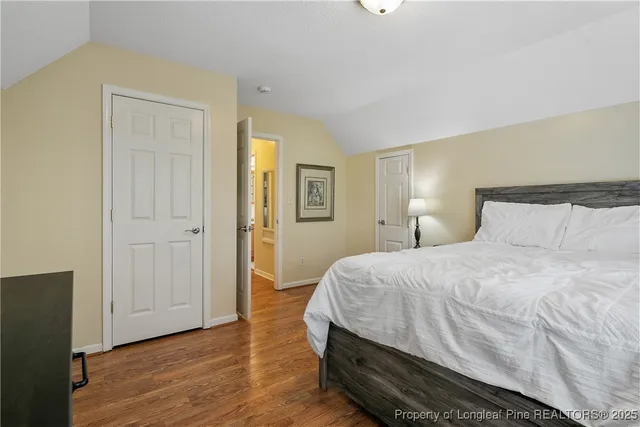 a large bed sitting in a bedroom next to a window