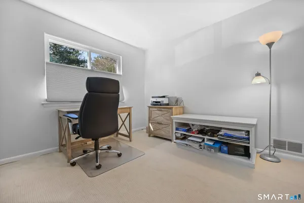 a bedroom with a bed and a table