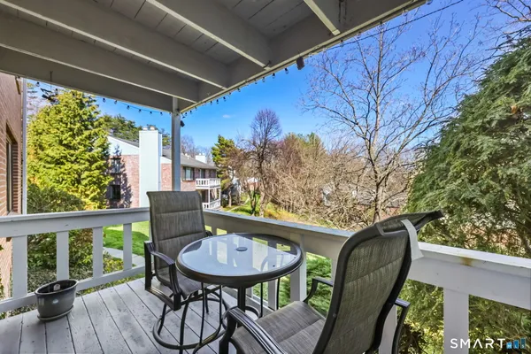 a view of balcony with furniture and wooden deck