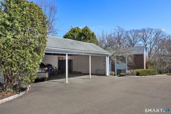 a living room with furniture a rug and a kitchen view