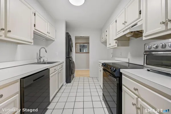 a kitchen with cabinets and chairs