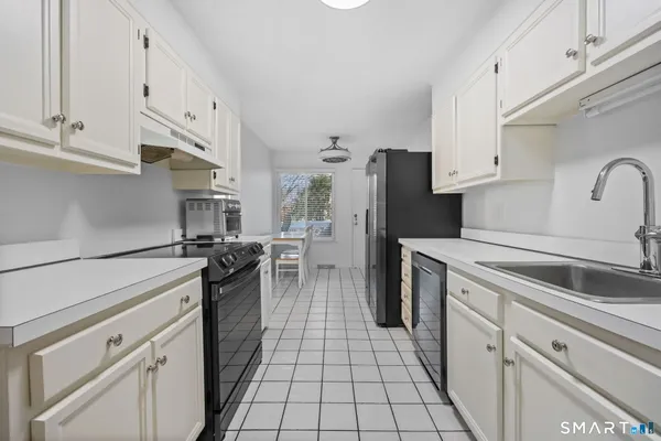 a bedroom with a large bed a flat tv screen and dresser