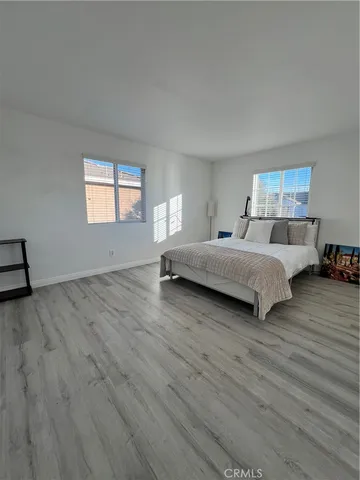 a spacious bedroom with a bed and window