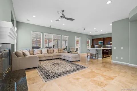 a living room with furniture and view of kitchen