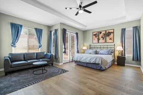 a bedroom with a bed couch and a window