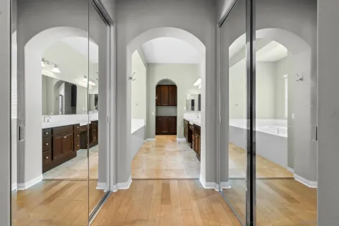 a view of a hallway with bathroom and glass door