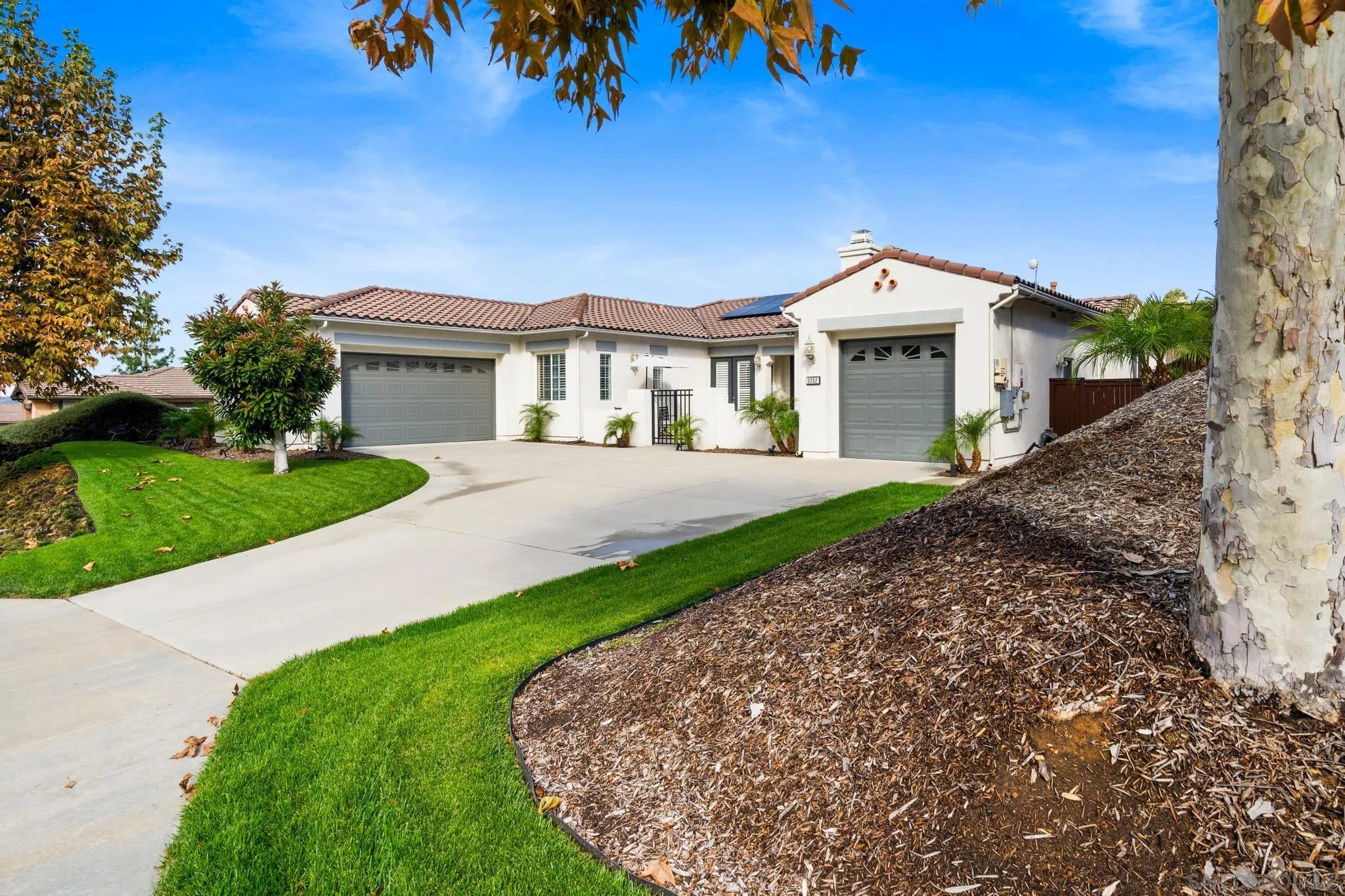3252 Hidden Estates Lane Escondido, CA 92027 - Photo 2 of 32 a front view of a house with a yard and potted plants