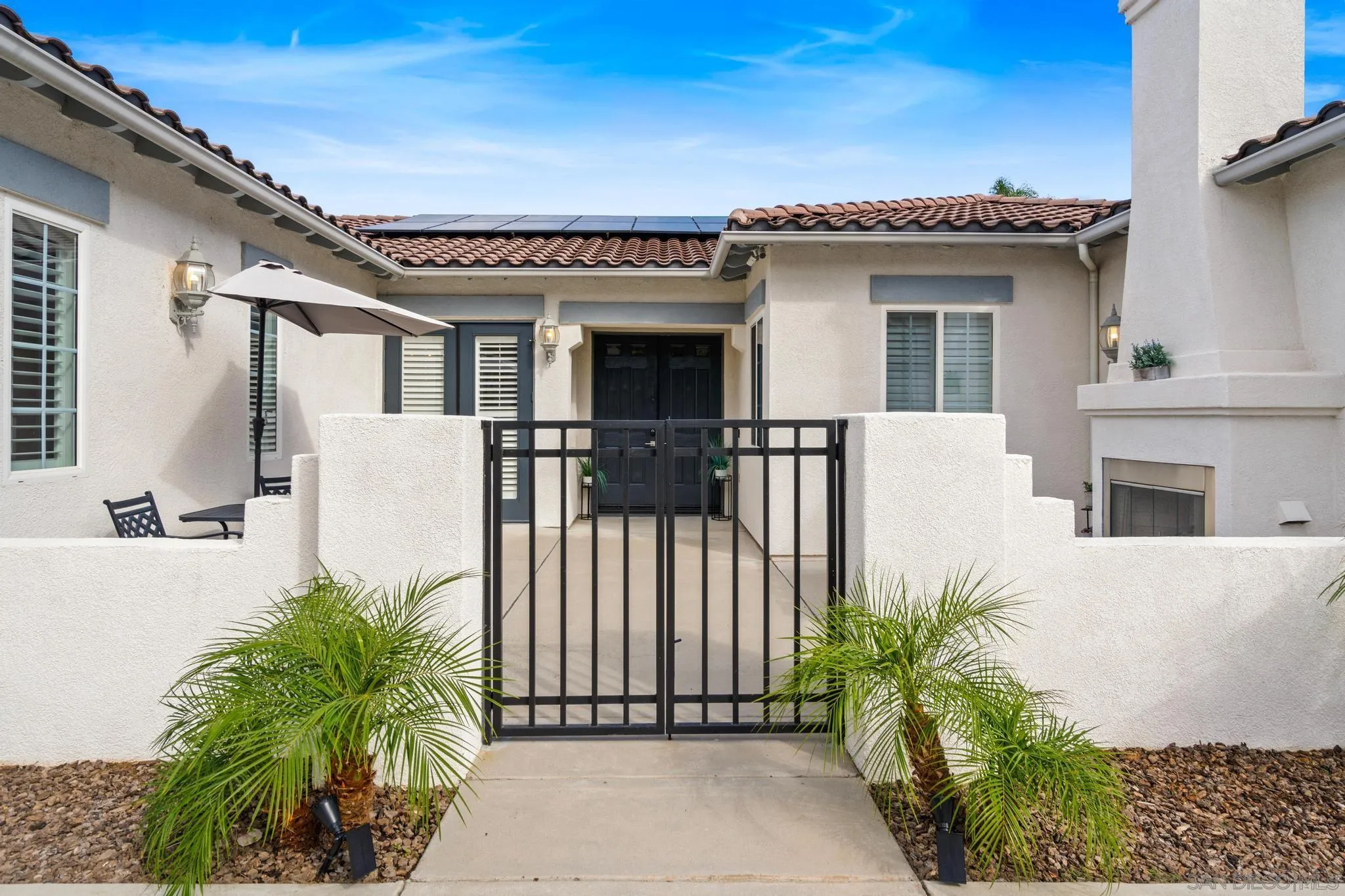 3252 Hidden Estates Lane Escondido, CA 92027 - Photo 3 of 32 a view of a house with a large window and potted plants