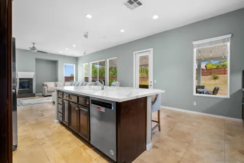 a kitchen with stainless steel appliances granite countertop a sink and a stove