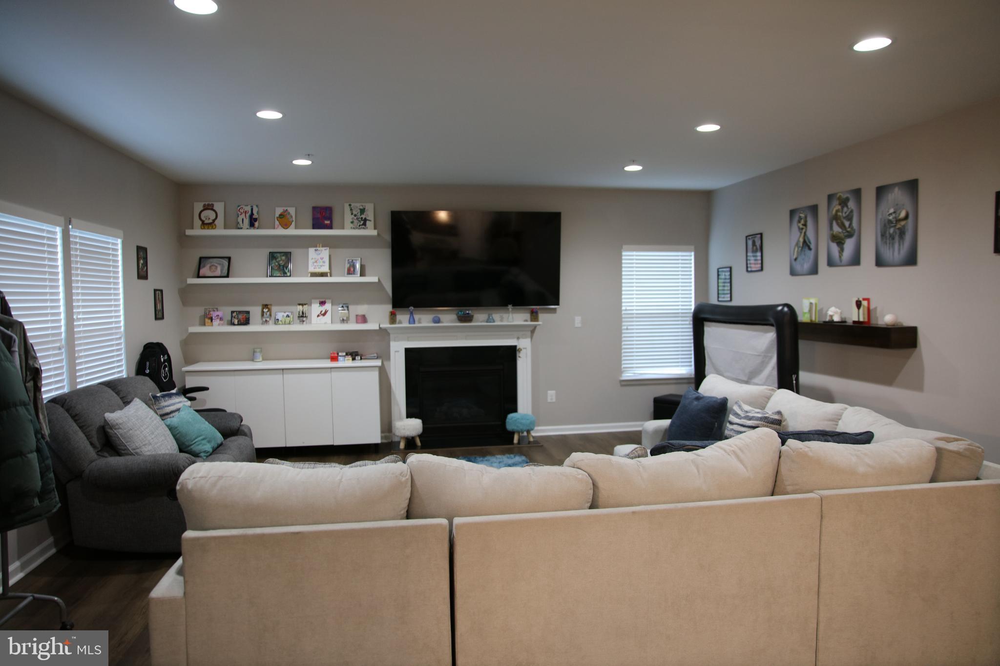 10431 Windlass Run Road Baltimore, MD 21220 - Photo 3 of 16 a living room with furniture a flat screen tv and a fireplace