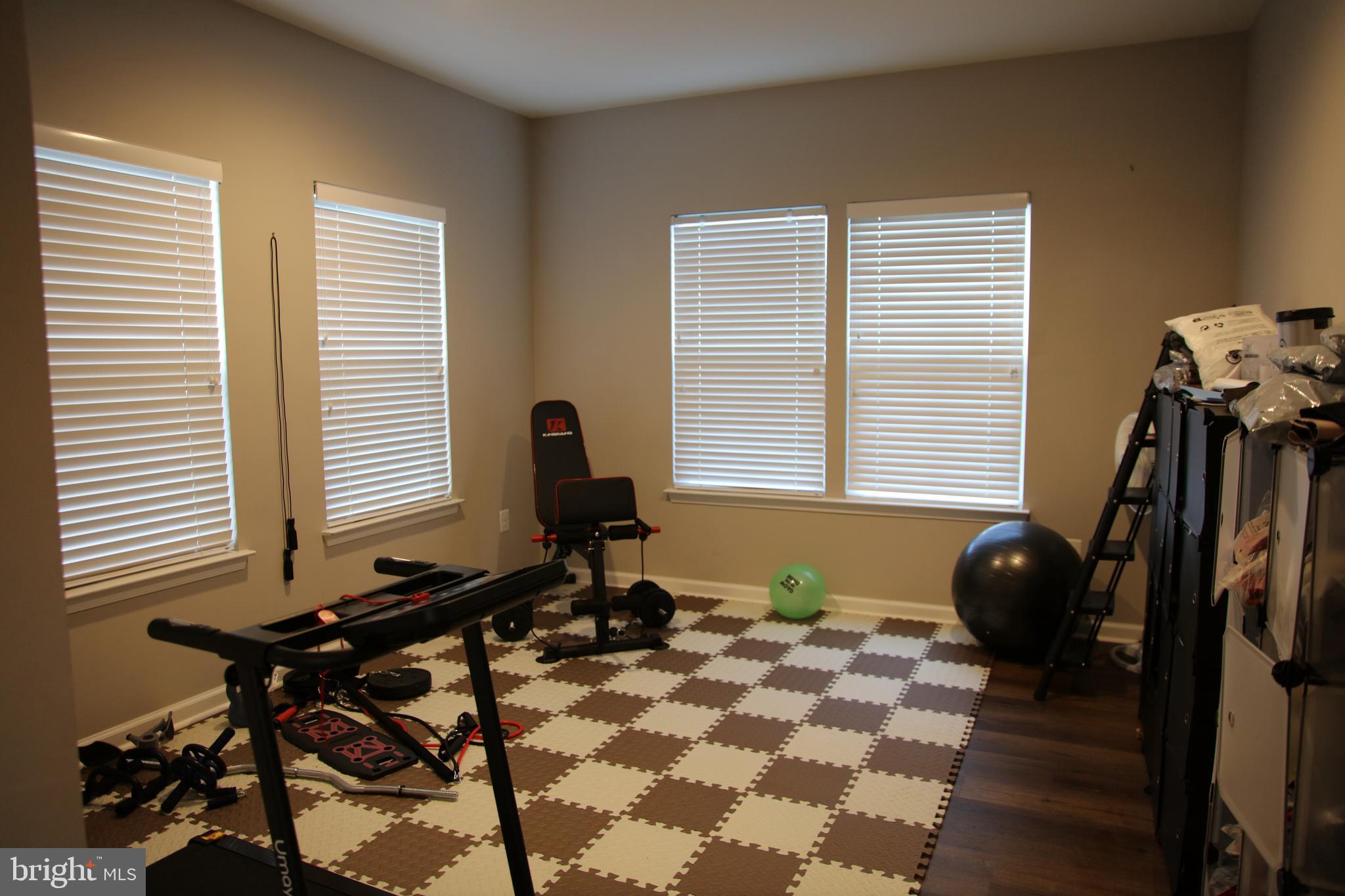 10431 Windlass Run Road Baltimore, MD 21220 - Photo 7 of 16 a room with gym equipment and windows