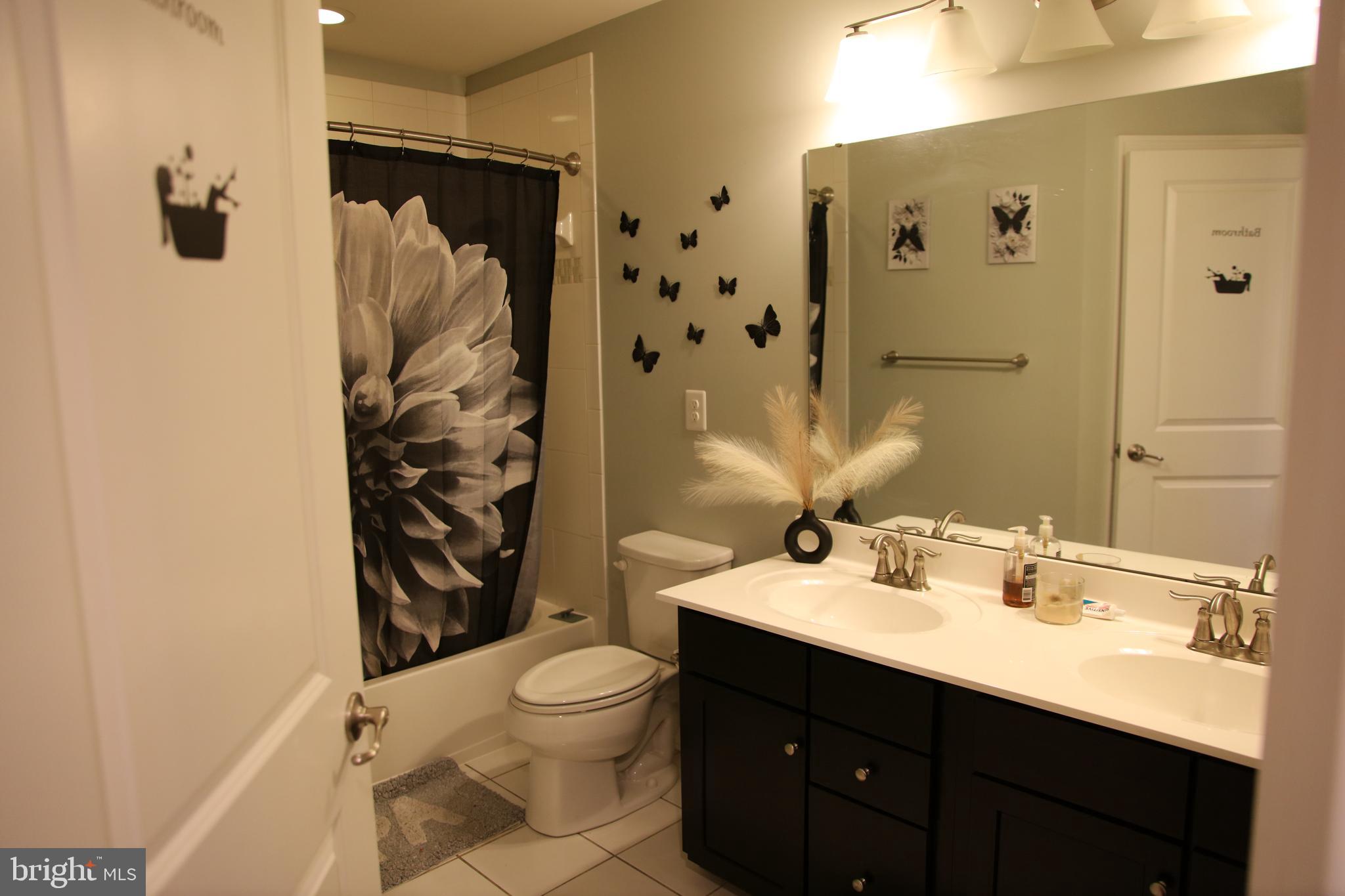 10431 Windlass Run Road Baltimore, MD 21220 - Photo 10 of 16 a bathroom with a sink toilet and shower