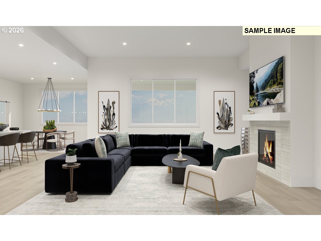 3807 South 16th Way, Unit L28 Ridgefield, WA 98642 - Photo 4 of 12 a living room with furniture a fireplace and a flat screen tv