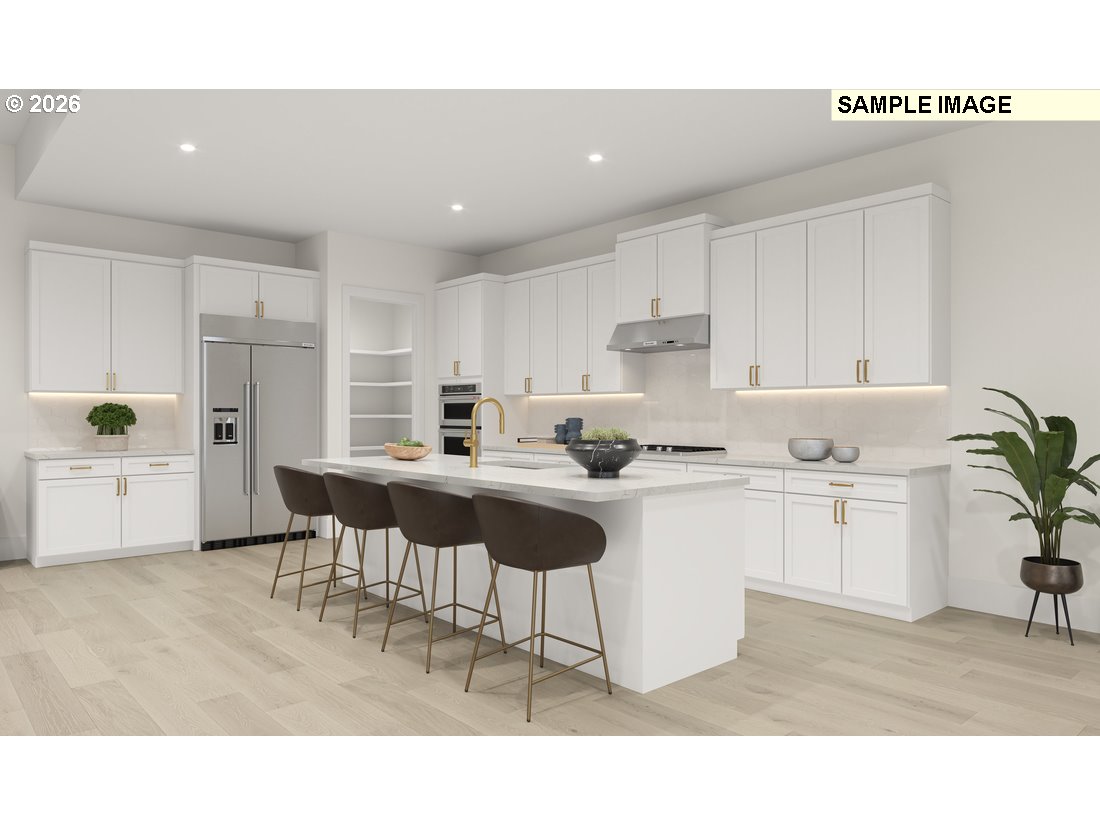 3807 South 16th Way, Unit L28 Ridgefield, WA 98642 - Photo 5 of 12 a kitchen with stainless steel appliances kitchen island granite countertop a sink and cabinets