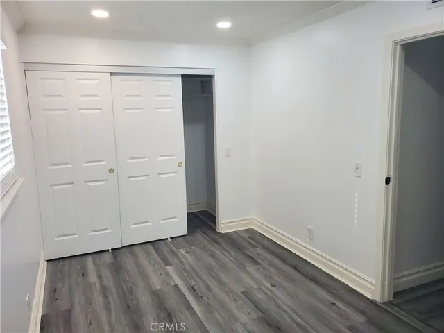 an empty room with wooden floor